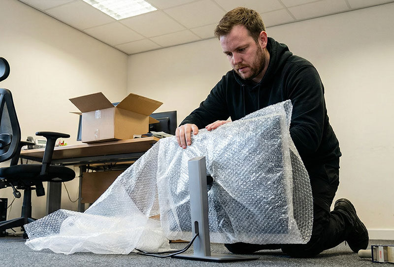 Office movers packing computers and electronics